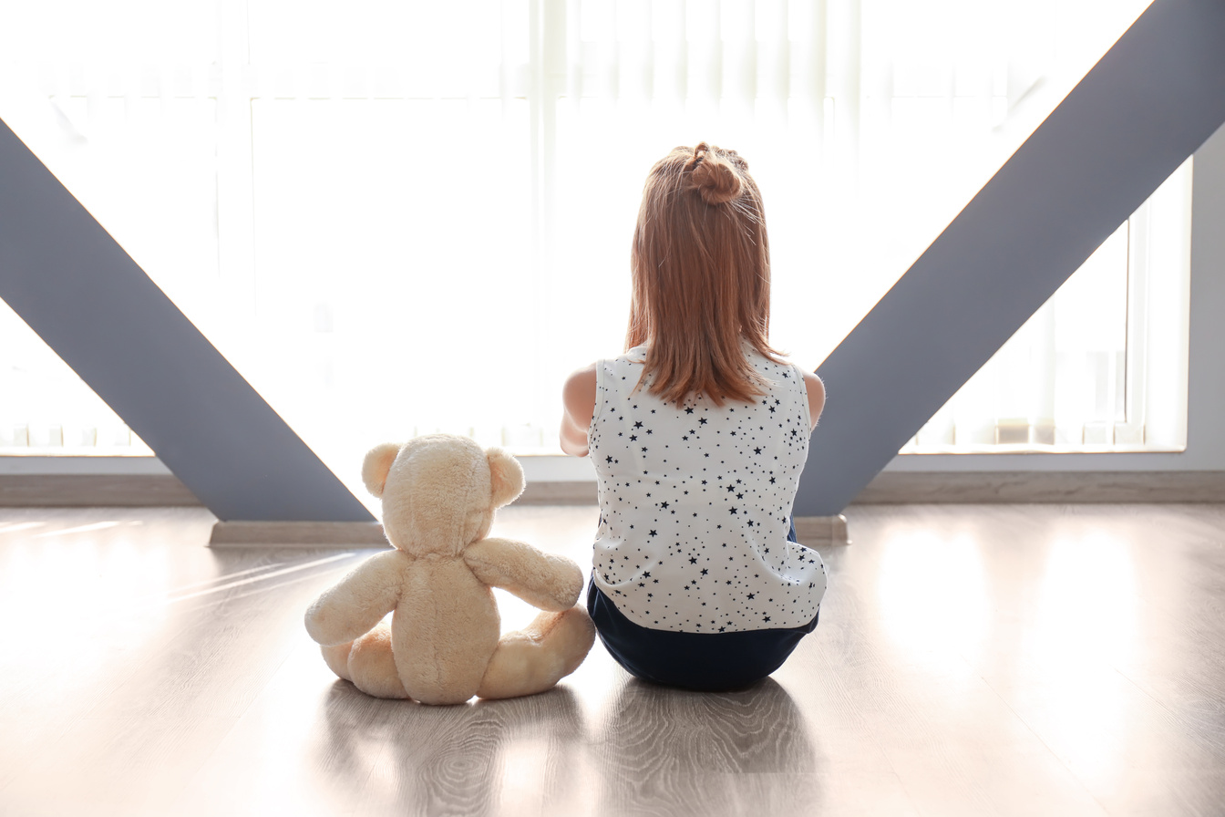 A Little Girl with Stuffed Teddy Bear for Autism Concept